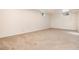Unfinished basement featuring a carpeted floor and a small window at 7695 S Harlan St, Littleton, CO 80128