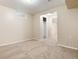 Carpeted basement room with natural light, offering a versatile living space at 7695 S Harlan St, Littleton, CO 80128