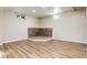 Cozy basement space featuring durable vinyl flooring and a unique corner stone fireplace at 7695 S Harlan St, Littleton, CO 80128