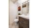 Contemporary bathroom with a stylish vanity, toilet, and decorative floral art at 7695 S Harlan St, Littleton, CO 80128