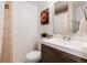 Bathroom featuring a modern vanity, toilet, and tiled shower with glass door at 7695 S Harlan St, Littleton, CO 80128