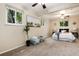 Bright bedroom offers carpeted floors, natural light, and neutral colors for a peaceful retreat at 7695 S Harlan St, Littleton, CO 80128