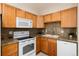 Charming kitchen featuring granite counters, stainless appliances, and updated cabinets at 7695 S Harlan St, Littleton, CO 80128