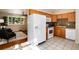Well-lit kitchen with stainless steel appliances, tile floors, granite countertops, and stylish modern cabinets at 7695 S Harlan St, Littleton, CO 80128