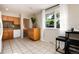 Bright kitchen nook featuring tile floors, ample cabinet space, a window view, and a cozy breakfast table at 7695 S Harlan St, Littleton, CO 80128