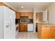 Well-appointed kitchen featuring granite countertops, white appliances, and ample cabinet space at 7695 S Harlan St, Littleton, CO 80128