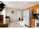 Bright kitchen with tile floors, white refrigerator, and granite countertops at 7695 S Harlan St, Littleton, CO 80128