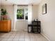 Bright kitchen nook featuring tile floors, ample cabinet space, a window view, and a cozy breakfast table at 7695 S Harlan St, Littleton, CO 80128