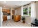 Bright kitchen features counterspace, a breakfast nook, and view to the backyard at 7695 S Harlan St, Littleton, CO 80128