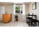 Functional kitchenette with counterspace, bar stool seating, and a large window at 7695 S Harlan St, Littleton, CO 80128