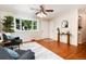 Bright living room with hardwood floors, ceiling fan and a bay window that offers plenty of natural light at 7695 S Harlan St, Littleton, CO 80128