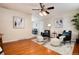 Inviting living room features hardwood floors, stylish seating, and a ceiling fan for added comfort at 7695 S Harlan St, Littleton, CO 80128