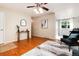 Bright, hardwood-floored living room with stylish decor and a warm, welcoming atmosphere with a ceiling fan at 7695 S Harlan St, Littleton, CO 80128
