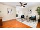 Open-concept living room showcasing hardwood floors, stylish decor, and a bright, inviting atmosphere for entertaining at 7695 S Harlan St, Littleton, CO 80128