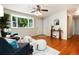 Bright living room with hardwood floors, cozy seating, and a large window with natural light at 7695 S Harlan St, Littleton, CO 80128