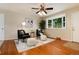 Cozy living room with hardwood floors, comfortable seating, and a bay window for natural light at 7695 S Harlan St, Littleton, CO 80128