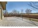 Wooden back deck overlooks green space and a fenced in area at 1960 E 166Th Dr, Thornton, CO 80602