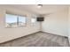 Bedroom showcasing neutral paint, carpet, with two windows providing natural light at 1960 E 166Th Dr, Thornton, CO 80602