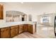 Bright kitchen showcasing an open layout, wood cabinets and modern backsplash at 1960 E 166Th Dr, Thornton, CO 80602