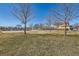 Grassy community park with a playground, covered picnic tables, and basketball court in the background at 1960 E 166Th Dr, Thornton, CO 80602