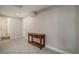 Finished basement area with neutral paint, carpet, and a decorative table at 2237 Barela Dr, Berthoud, CO 80513