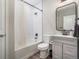 Bathroom features a shower-over-tub, a sleek mirror, and modern fixtures at 2237 Barela Dr, Berthoud, CO 80513