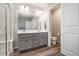 Stylish bathroom featuring a double sink vanity, plank flooring, and a toilet at 2237 Barela Dr, Berthoud, CO 80513