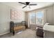 A stylish, cozy bedroom features a ceiling fan and bright natural light at 2237 Barela Dr, Berthoud, CO 80513