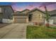 Two-story house with gray siding, stone accents, and a two-car garage at 2237 Barela Dr, Berthoud, CO 80513