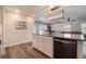 Open concept kitchen with center island bar and stainless appliances; view to living room at 2237 Barela Dr, Berthoud, CO 80513