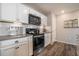 Modern kitchen with stainless steel appliances, lots of countertop space, and tiled backsplash at 2237 Barela Dr, Berthoud, CO 80513