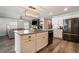 Open concept kitchen with large island, stainless steel appliances, and white cabinets at 2237 Barela Dr, Berthoud, CO 80513