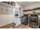 Laundry room with modern washer and dryer units, shelving, and storage baskets at 2237 Barela Dr, Berthoud, CO 80513