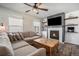 Inviting living room featuring a fireplace, wood floors, and a comfortable sectional couch at 2237 Barela Dr, Berthoud, CO 80513