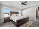 Bright main bedroom featuring a ceiling fan, wood flooring, and bedside tables at 2237 Barela Dr, Berthoud, CO 80513