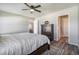 View of the main bedroom including a wood dresser, ceiling fan, and plank flooring at 2237 Barela Dr, Berthoud, CO 80513