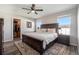 Spacious main bedroom featuring a large bed, ceiling fan, ensuite bathroom and walk-in closet at 2237 Barela Dr, Berthoud, CO 80513