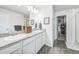 Primary bath featuring double sinks with granite countertops and access to the walk-in closet at 19197 E 64Th Ave, Denver, CO 80249