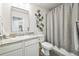 Well-lit bathroom with granite countertop vanity and decorative metal flower embellishment at 19197 E 64Th Ave, Denver, CO 80249