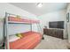 Comfortable bedroom with bunk beds, dresser, and TV at 19197 E 64Th Ave, Denver, CO 80249