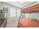 Bedroom with carpet, two windows, and bunk beds at 19197 E 64Th Ave, Denver, CO 80249