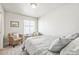 Bedroom with neutral colors, woven chair, and ample natural light at 19197 E 64Th Ave, Denver, CO 80249