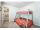 Cozy bedroom featuring bunk beds and a closet at 19197 E 64Th Ave, Denver, CO 80249