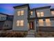 Stylish townhome exterior showcases a contemporary design with a welcoming front entrance and ample natural light at 19197 E 64Th Ave, Denver, CO 80249