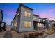 Modern gray two-story home exterior with a low maintenance landscape and a walkway at 19197 E 64Th Ave, Denver, CO 80249