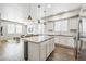 Bright, modern kitchen with stainless steel appliances and granite countertops opens to living area at 19197 E 64Th Ave, Denver, CO 80249