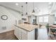 Open concept kitchen to living room with granite counters and stainless appliances at 19197 E 64Th Ave, Denver, CO 80249