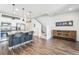 Modern open-concept kitchen with granite countertops, stainless steel appliances, and dark wood flooring at 19197 E 64Th Ave, Denver, CO 80249