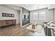 Living room with hardwood floors, a dark accent wall, and a gray couch at 19197 E 64Th Ave, Denver, CO 80249