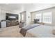 Spacious main bedroom with desk, TV, and good natural light at 19197 E 64Th Ave, Denver, CO 80249